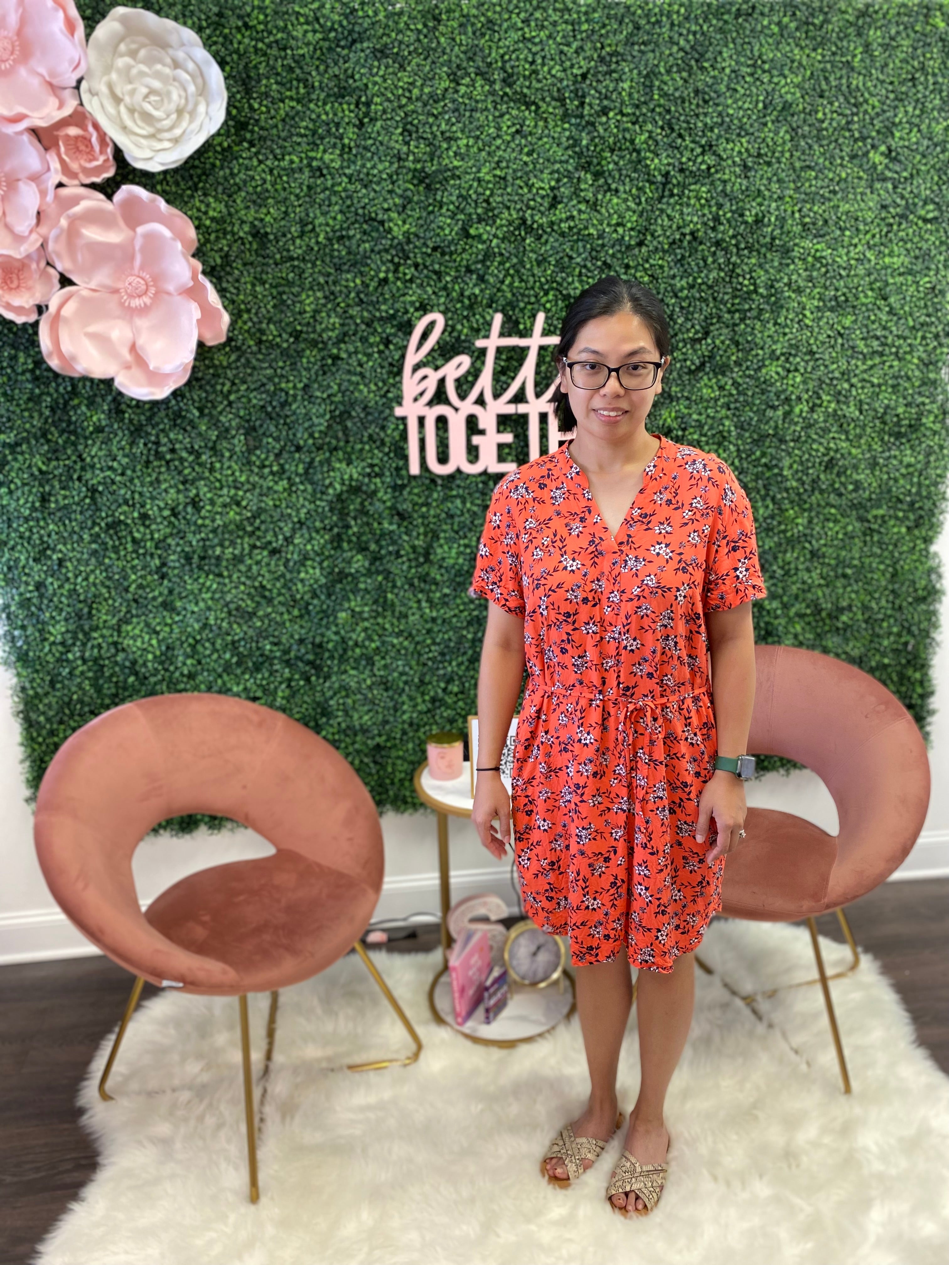 Young woman in pink dress before her styling service